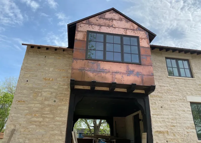 Copper metal panel facade on a stone building for Roof Repair in Rock Hill