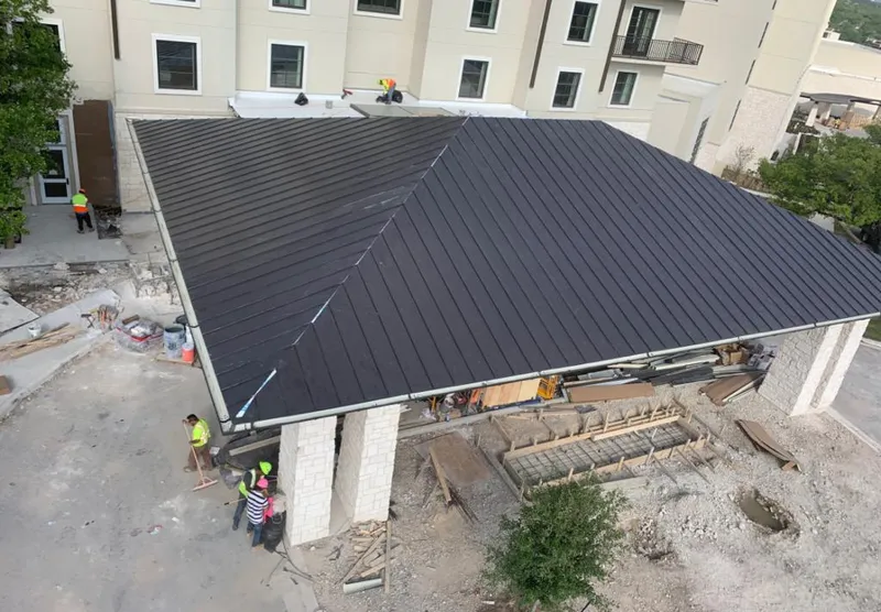 Metal roofing installation team working on a commercial building in Rock Hill