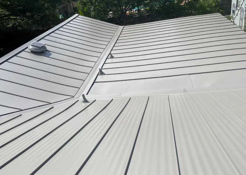 Solar attic fan installed on a metal roof for Roof Ventilation in Rock Hill
